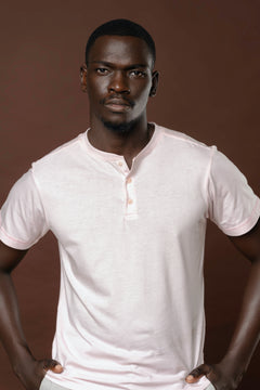 Model wearing Dapperly Henley Blush, hands on hips, confident portrait pose